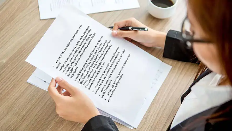 Office worker reading a large print document.